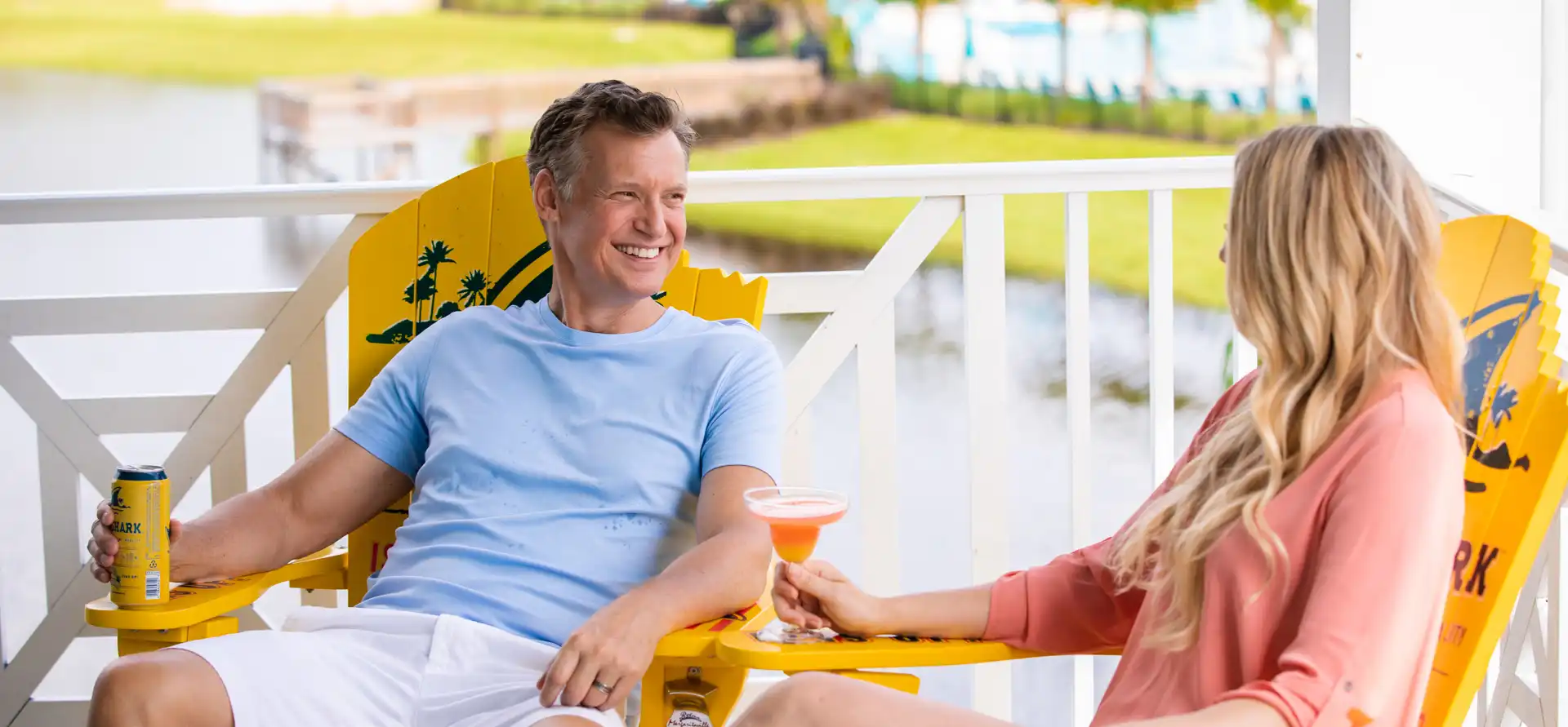Couple relaxing on a covered balcony of their private cottage, demonstrating why buy at Margaritaville Beach Cottage Resort Galveston, TX