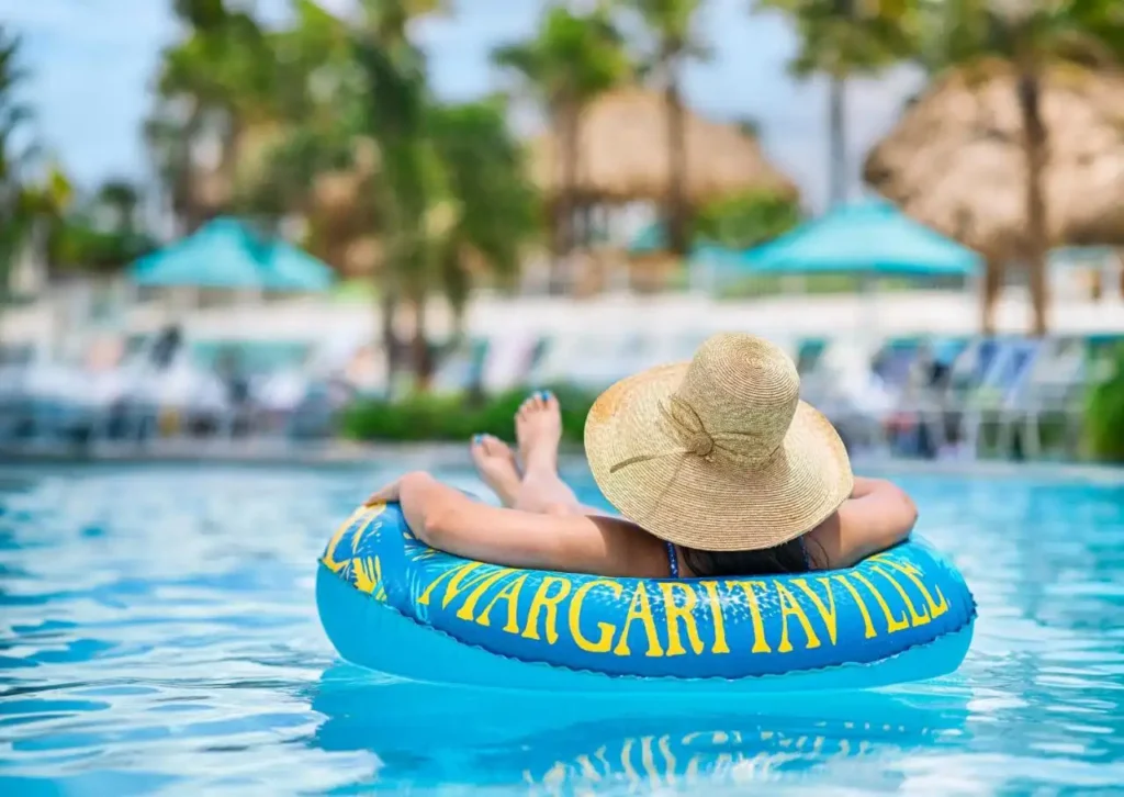Woman relaxing in a Margaritaville float in a resort pool