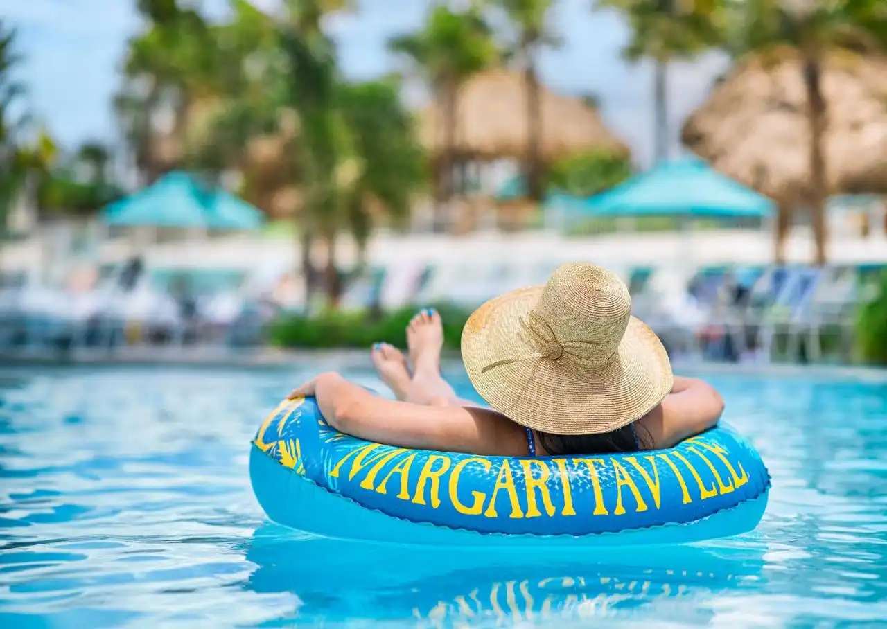 Woman relaxing in a Margaritaville float in a resort pool